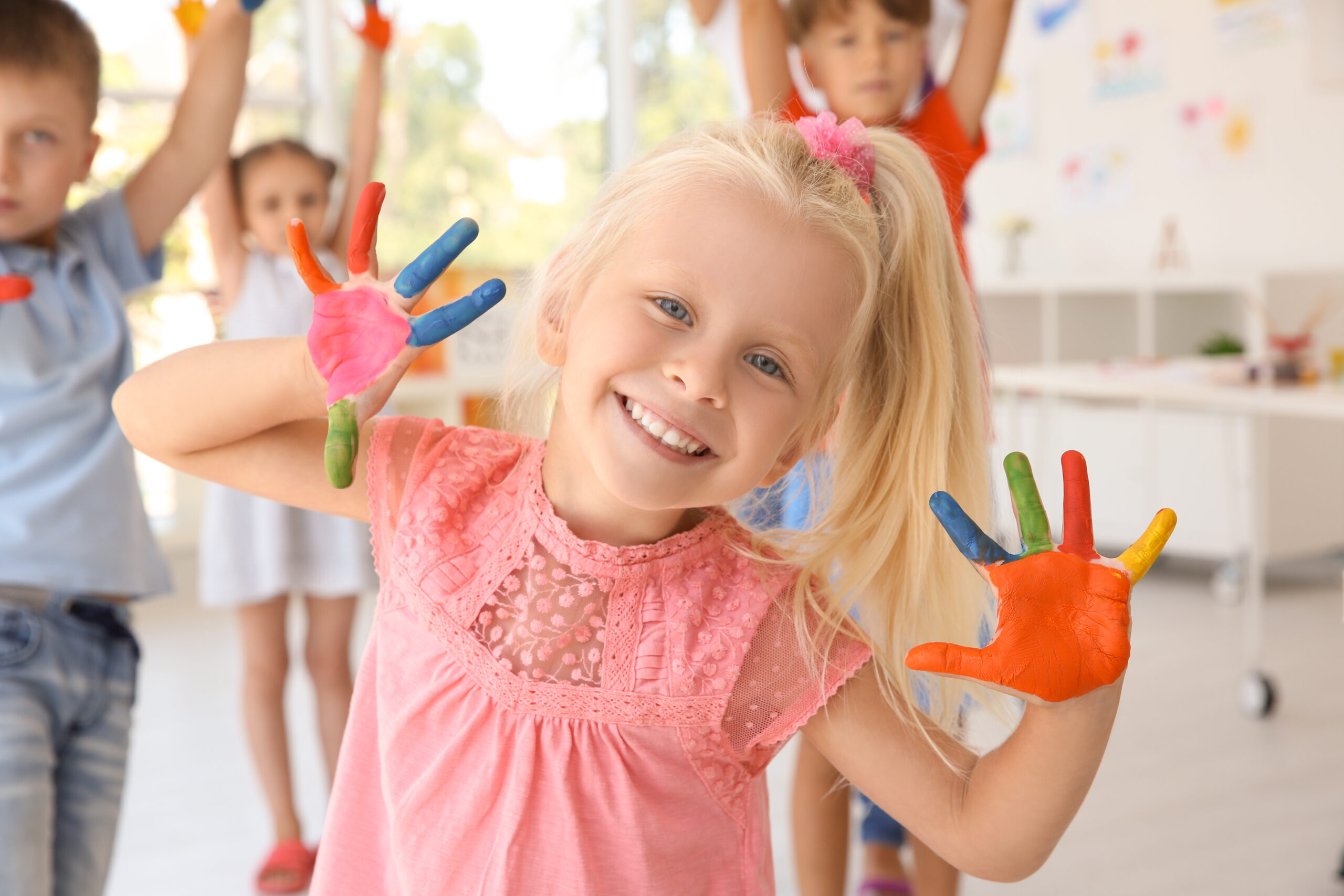 Little girl with hands in paint at art lesson Little girl with hands in paint at art lesson